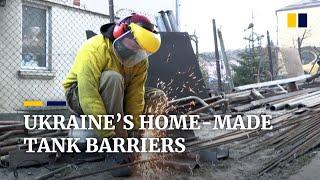 Ukrainians weld anti-tank obstacles to help fight invading Russian troops