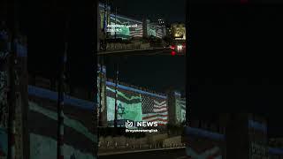“Israel” projects US flag on Jerusalem walls to thank America for Iran strike