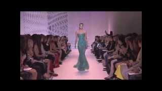 Model Pauline Hoarau trips during Zuhair Murad Haute Couture Fall/Winter 2014-2015