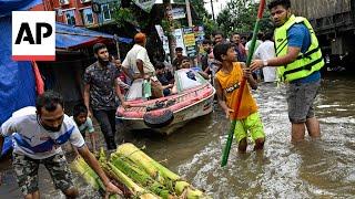 Rescuers struggle to reach people stranded by deadly floodwaters in eastern Bangladesh