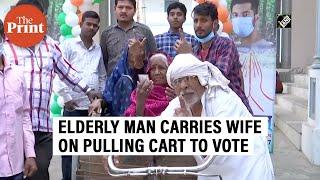 Elderly man carries wife on pulling cart to cast vote in Azamgarh, Uttar Pradesh