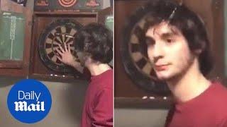 Dart flies into man's HEAD... but he doesn't seem to notice - Daily Mail