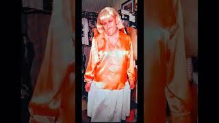 Wendy wearing a orange satin blouse