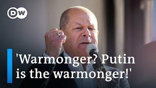 German Chancellor Scholz throws angry response at chants of 'warmonger' | DW News