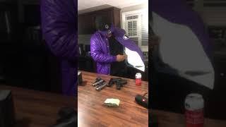 RAPPER HITMANFLOYD PULL  100 GUNS OUT A JACKET ON SET OF GUCCI GANG 