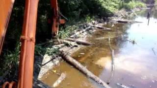 breaking beaver dam to build logging road part 1