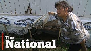 First Nation family waiting in sewage for new home