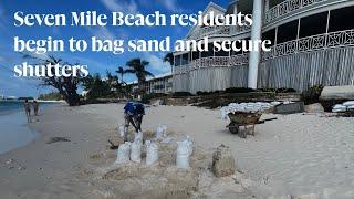 Seven Mile Beach residents begin to bag sand and secure shutters