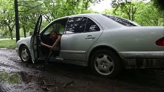 Brunette tries to drive Mercedes through muddy road and gets stuck