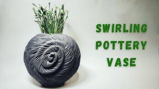 making a swirling pottery vase