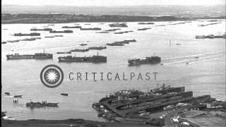 Ships and invasion craft  anchored in  Portland harbor, England, during World War...HD Stock Footage