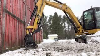 Huge ice problem after a polar vortex froze the doors in on our barn, CAT 306 destroys the problem.