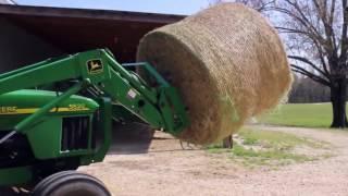 Picking up hay bails with Titan hay spear attachment for John Deere