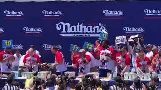 Joey Chestnut bodies protester during hot dog eating contest