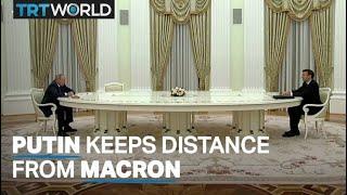 Putin meets Macron in Moscow but keeps him away with a long table