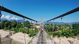 walking across the hanging bridge  over tirsule river on my way to devghat at chitwan