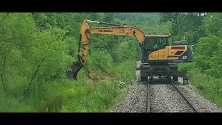 Trains and a Hi Rail Excavator Ditching along the Track