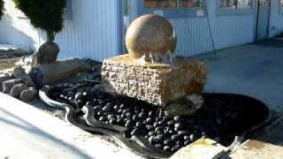 StoneBella floating sphere water fountain. Solid ball spins on water