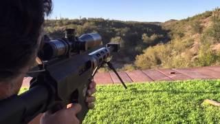 Close up slow-mo shooting a Bushmaster BA50 .50 BMG