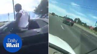 Driver speeds down highway while hanging out of car window - Daily Mail