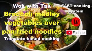 Wok with Tak.  Broccoli medley vegetables over pan-fried noodles.  Template-based cooking.