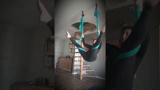 Aerial yoga trick from key straddle