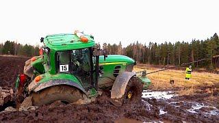 HEAVY JOHN DEERE tractor got stuck in the mud. You won't be able to get out without outside help.