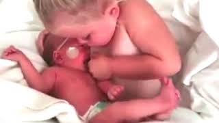 Little girl breastfeed her younger brother