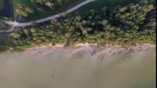 Slow Vertical Landing Over Lake And Forest - cutestockfootage.com