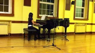 Cathy Ng  playing the piano in a sch concert