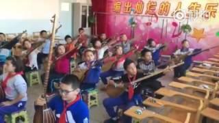 Uyghur kids learning Duttar