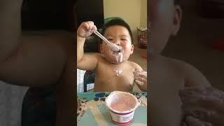 Cute Chubby Asian Baby Eats Yogurt