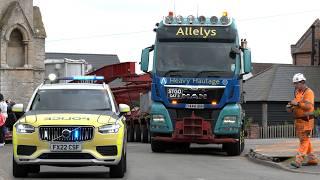 88 wheeled vehicle squeezes through English village with police escort