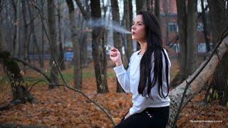 Gorgeous fitness trainer Tanya is smoking a cigarette in the park