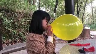 Looner girl blow to pop three balloons