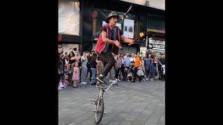 Catching Fire: A Torch Juggler's Performance on Leicester Square in London