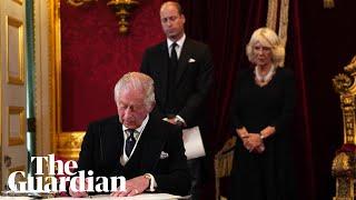 King Charles signals to aide to remove pens during signing of oath