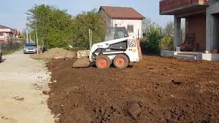 Bobcat 553 leveling soil