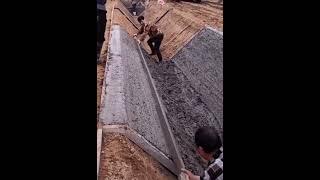 Making concrete drainage ditch with skilled construction workers
