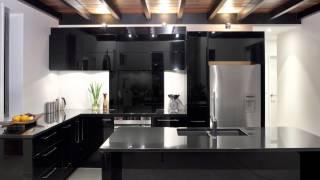 Sleek kitchen recedes from the eye and achieves maximum functionality in a modest space