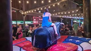 Pretty Girl in Blue Dress Riding on a Bull in Benidorm | Mechanical Bull 4K.