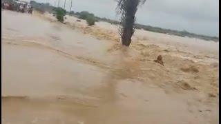 A man being swept away by heavy water at the Ramisi bridge