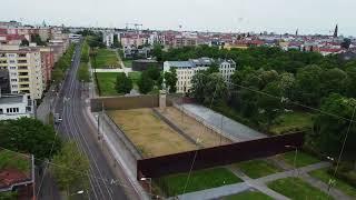 Aerial panoramic view of urban borough and Berlin Wall Memorial. Part of original wall historic