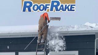 Clearing Snow From Roof With A Roof Rake