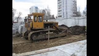 Old soviet dozer tractor T-170 and tower crane KB-504