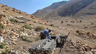 Iran's nomadic life: making a water trough for sheep with natural stone in the mountains