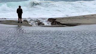 Heavy Rain Leads to River Breaching Sand Berm