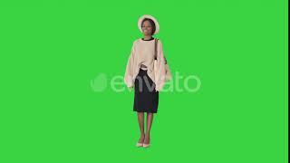 Fashionable African American Woman Posing in Knitwear and White Hat on a Green Screen, Chroma Key