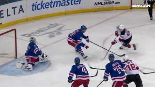 Jack Hughes scores a goal against the New York Rangers