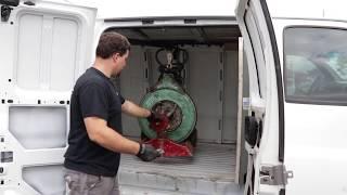 Custom hoists lift sewer cable machines into van